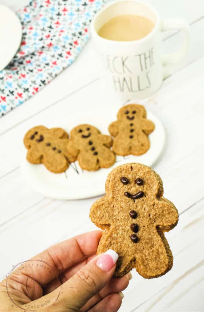 womans hand holding keto gingerbread cookie