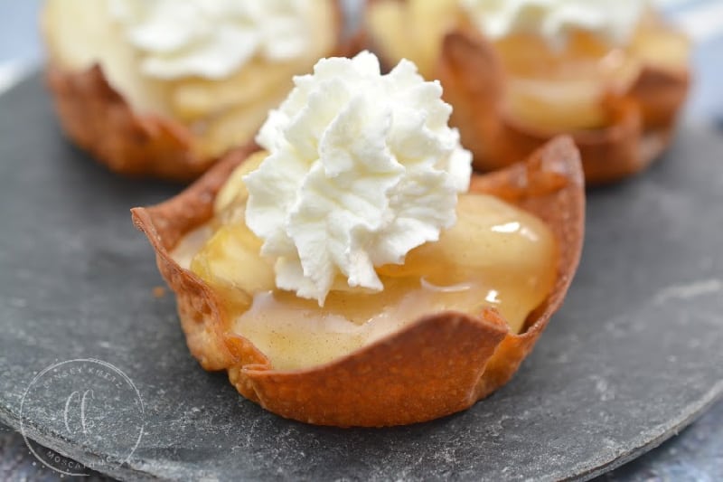 mini apple pies with whipped cream topping