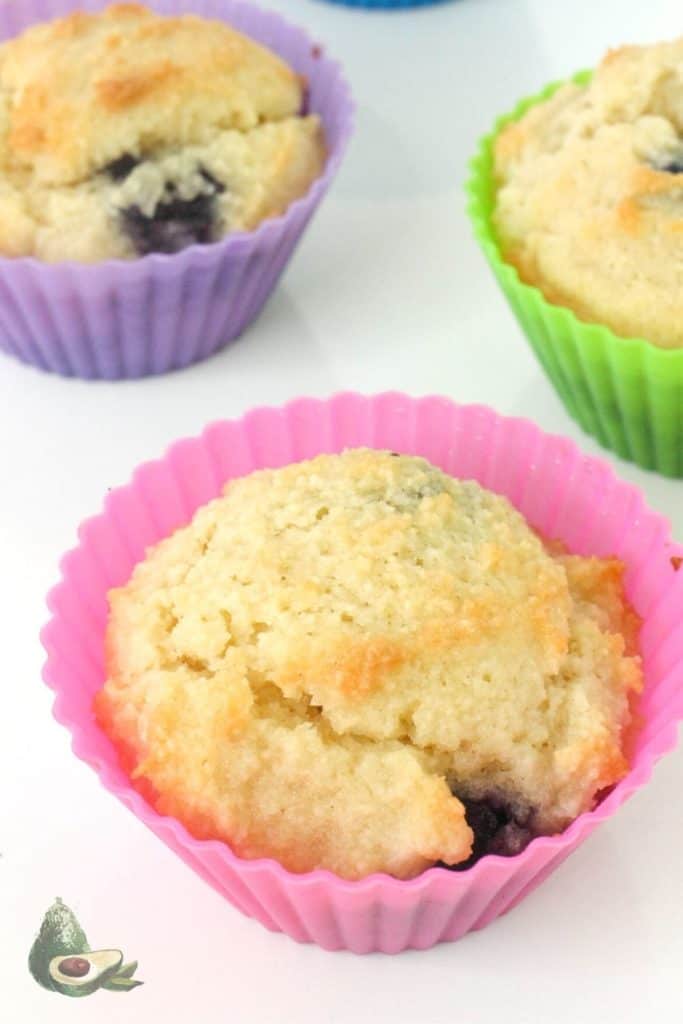 close up of low carb blueberry muffin in pink liner