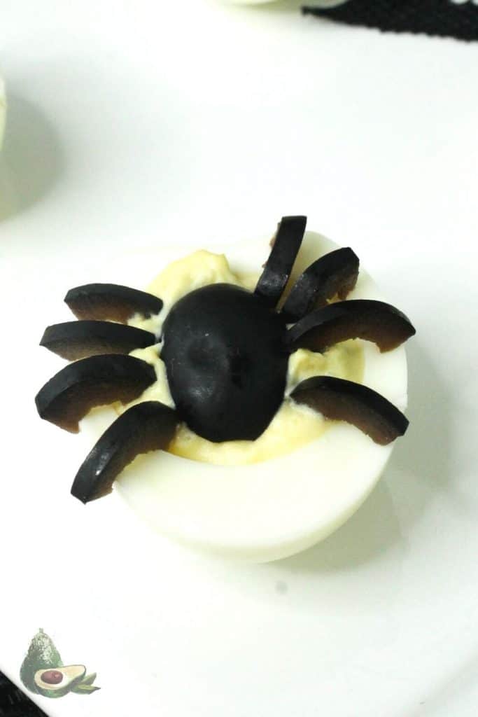 black olive spider on deviled egg