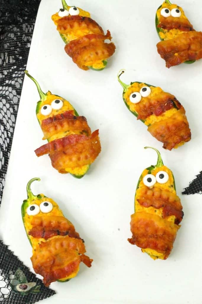 plate of bacon wrapped jalapeno popper mummies