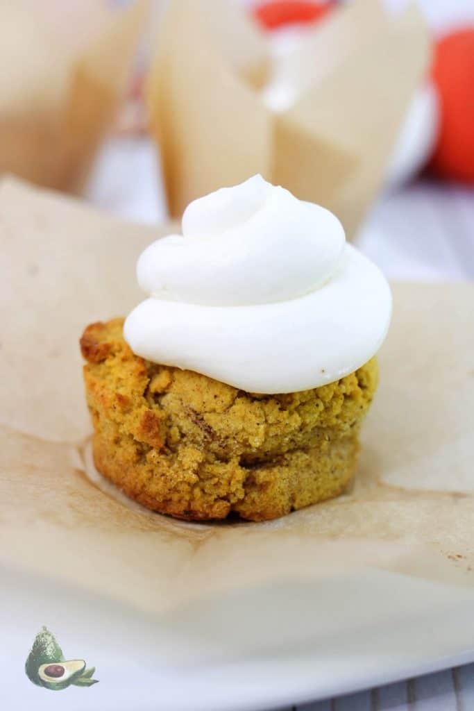 close up keto pumpkin muffin with cream cheese icing